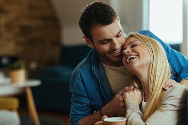 A smiling couple relaxing together at home